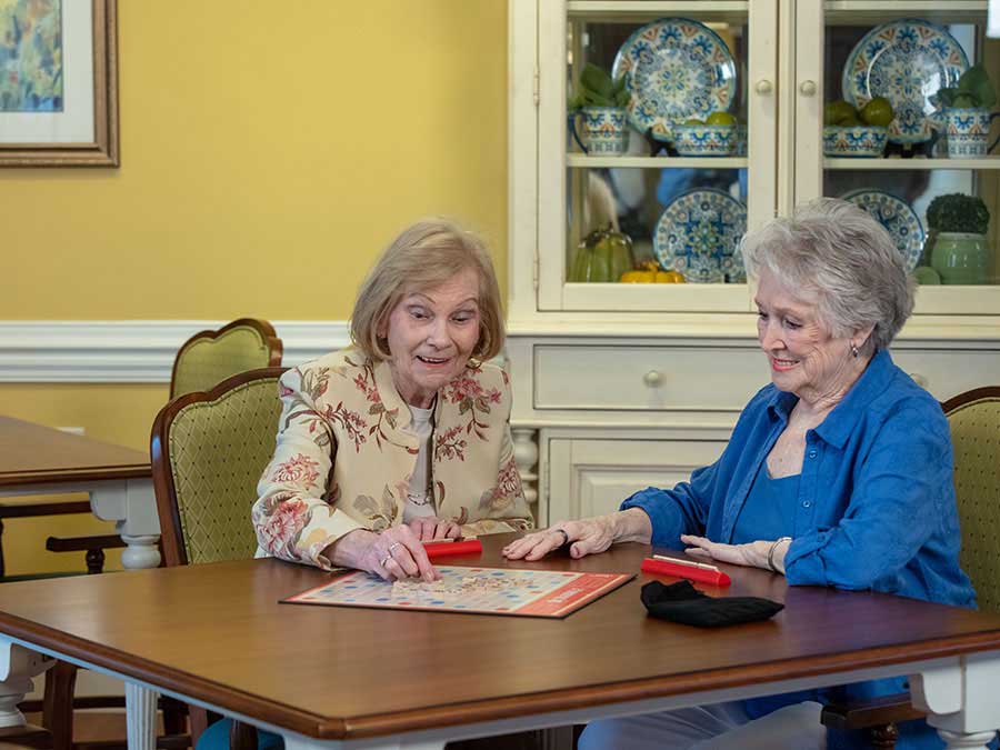 Playing Scrabble at The Terrace memory care units in Charlotte