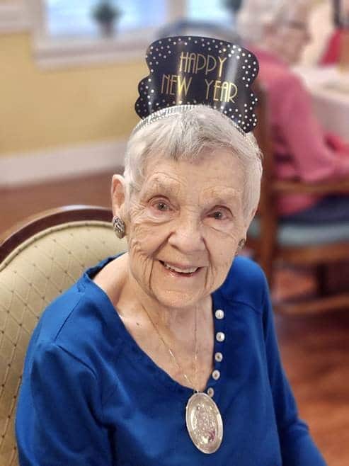 Senior in blue with New Year hat
